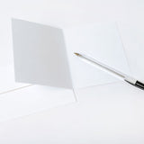 White card with a pen on a white background