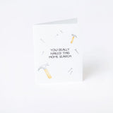 Greeting card with text 'You really nailed this home search' on a white background