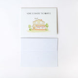 Greeting card with house illustration and text 'Home is where the Wi-Fi is' on a white background