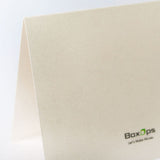Greeting card close-up shot showing the premium pearl shimmer material, with a BoxOps logo printed on it.