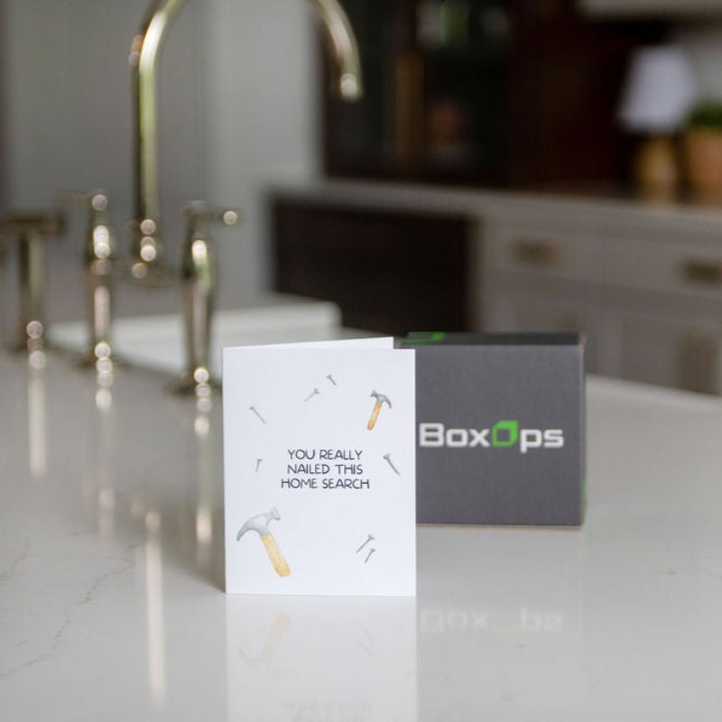 BoxOps product on a kitchen counter with a card reading 'You really nailed this home search'.