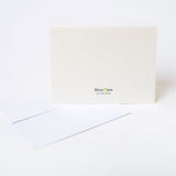 Beige moving greeting card on a white background with BoxOps logo printed on the back of the card.