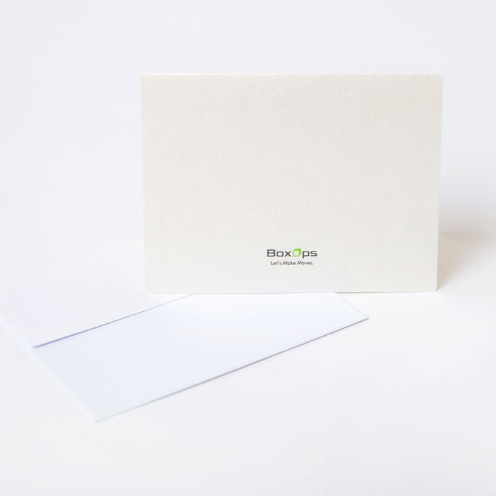 Beige moving greeting card on a white background with BoxOps logo printed on the back of the card.