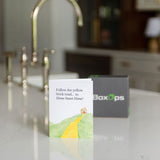 Card with a yellow brick road illustration on a kitchen counter with BoxOps branding.