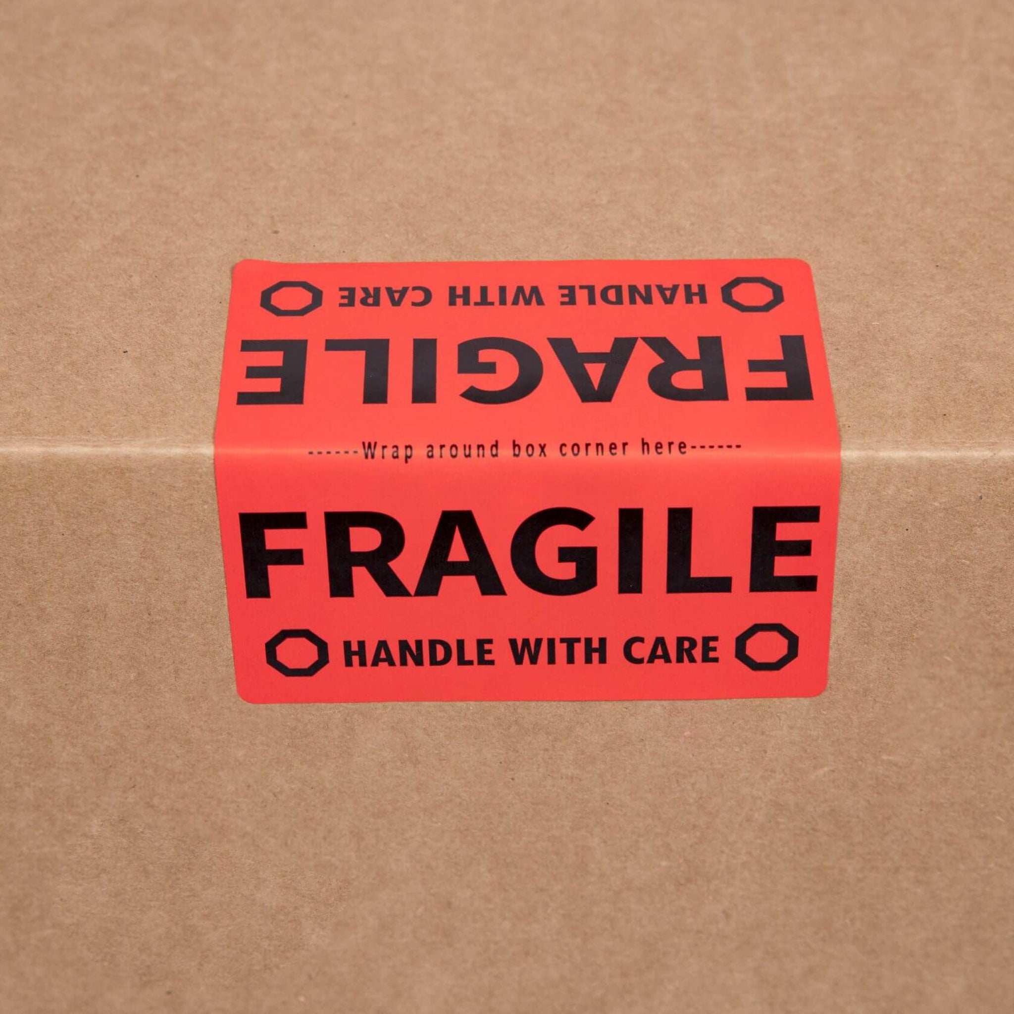 red fragile packing label on a moving box