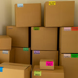 A group of cardboard moving boxes with color-coded moving labels to sort boxes by rooms and categories.