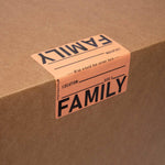 Cardboard box with 'FAMILY' label on a brown background