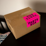 Cardboard moving box labeled 'Parts Box'