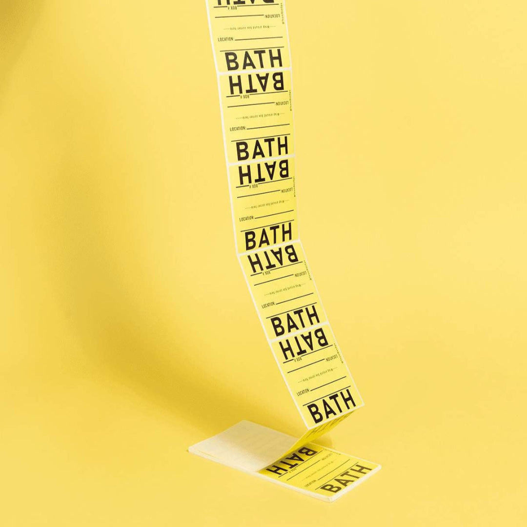 Long strip of yellow labels with 'BATH' printed on them against a yellow background.
