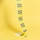 Long strip of yellow labels with 'BATH' printed on them against a yellow background.