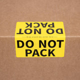 Yellow 'DO NOT PACK' label on a cardboard moving box