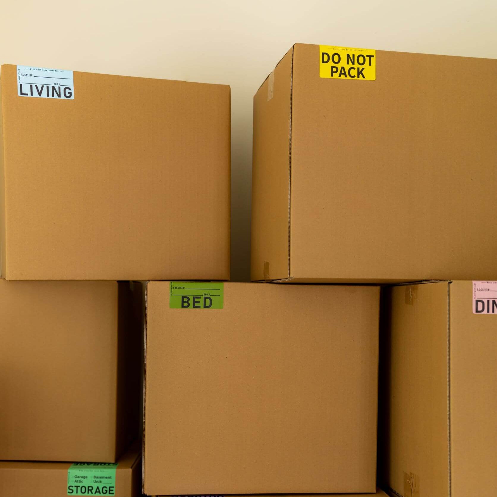 stacked moving boxes with labels