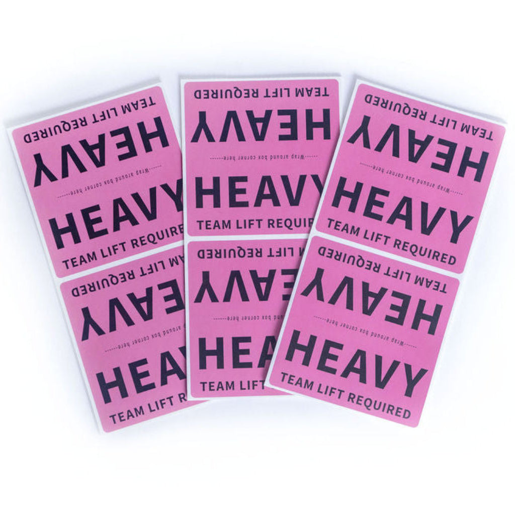 Three maroon labels with 'HEAVY TEAM LIFT REQUIRED' text on a white background