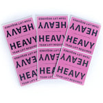 Three maroon labels with 'HEAVY TEAM LIFT REQUIRED' text on a white background