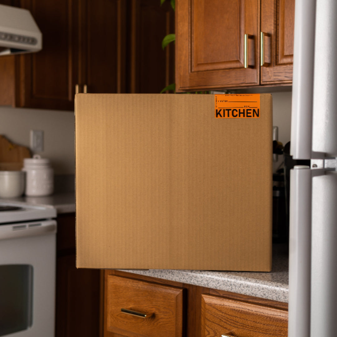 Wooden cabinet door with 'KITCHEN' label in a kitchen setting