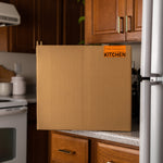 Wooden cabinet door with 'KITCHEN' label in a kitchen setting