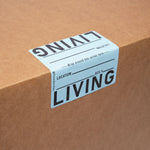Cardboard box with 'LIVING' label on a brown background