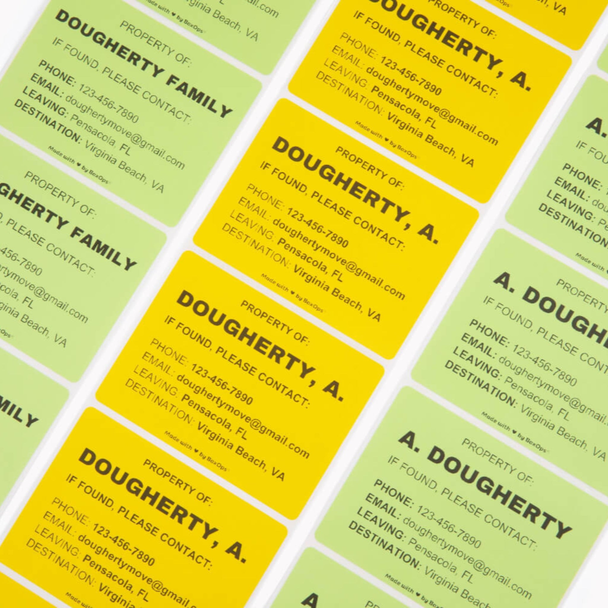 A collection of property ID stickers in green and yellow, with printed text including names and contact information.