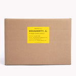 A yellow box label sticker with a name and contact information on it for finding missing moving boxes.