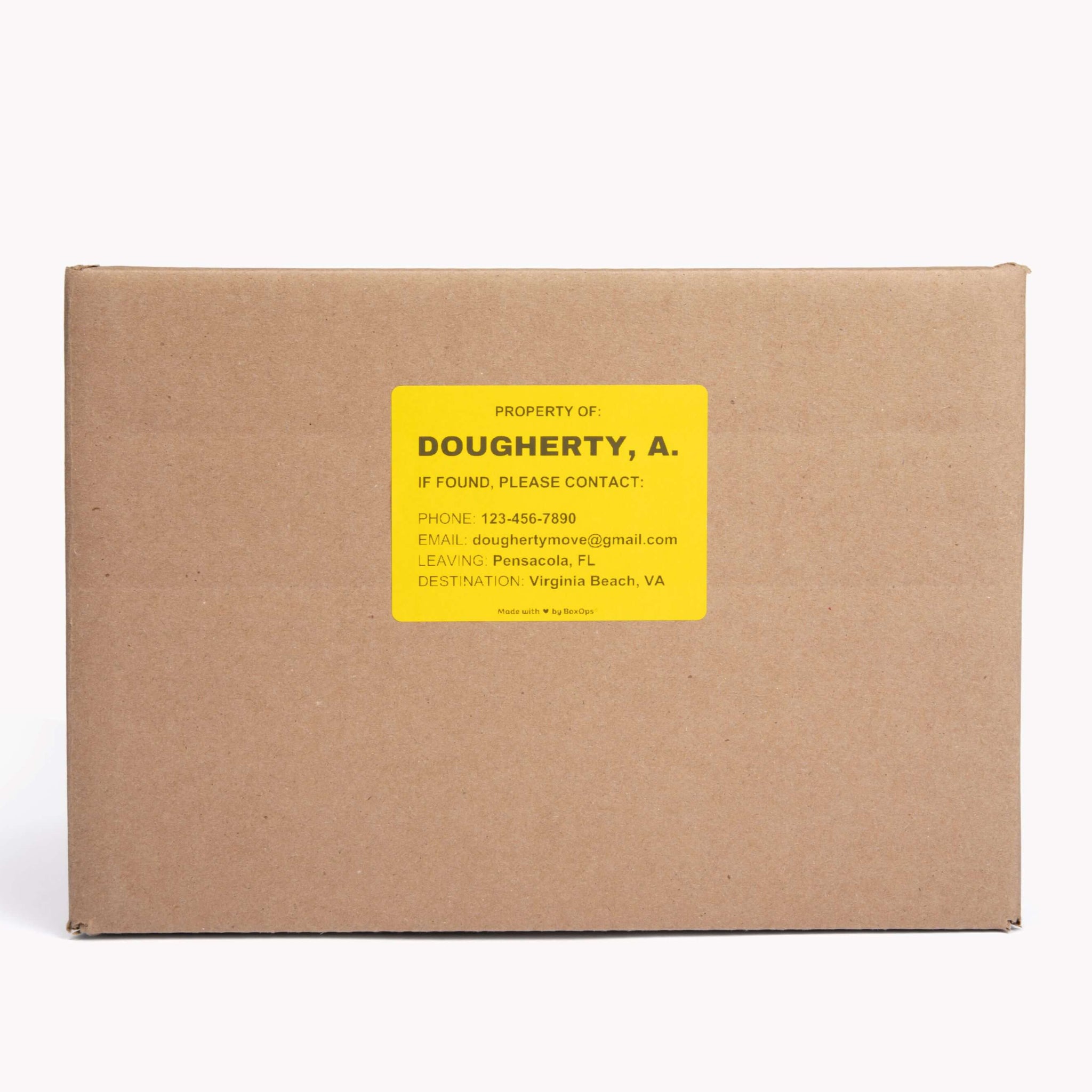 A yellow box label sticker with a name and contact information on it for finding missing moving boxes.