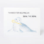 Greeting card with an illustration of a seal with a key and text reading 'Thanks for helping us seal the deal' on a white background