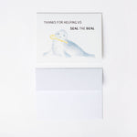 Card with a seal illustration and text 'Thanks for helping us seal the deal' on a white background with A2 envelope