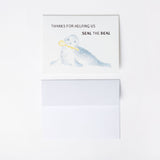 Card with a seal illustration and text 'Thanks for helping us seal the deal' on a white background with A2 envelope