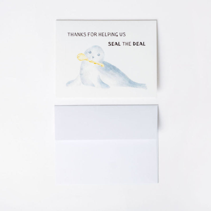 Card with a seal illustration and text 'Thanks for helping us seal the deal' on a white background with A2 envelope