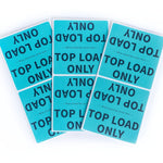 Multiple blue labels with 'Top Load Only' text on a white background