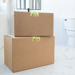 Two cardboard boxes labeled 'Bath' in a bathroom setting.