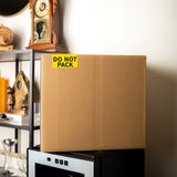 Yellow DO NOT PACK label on a cardboard moving box 